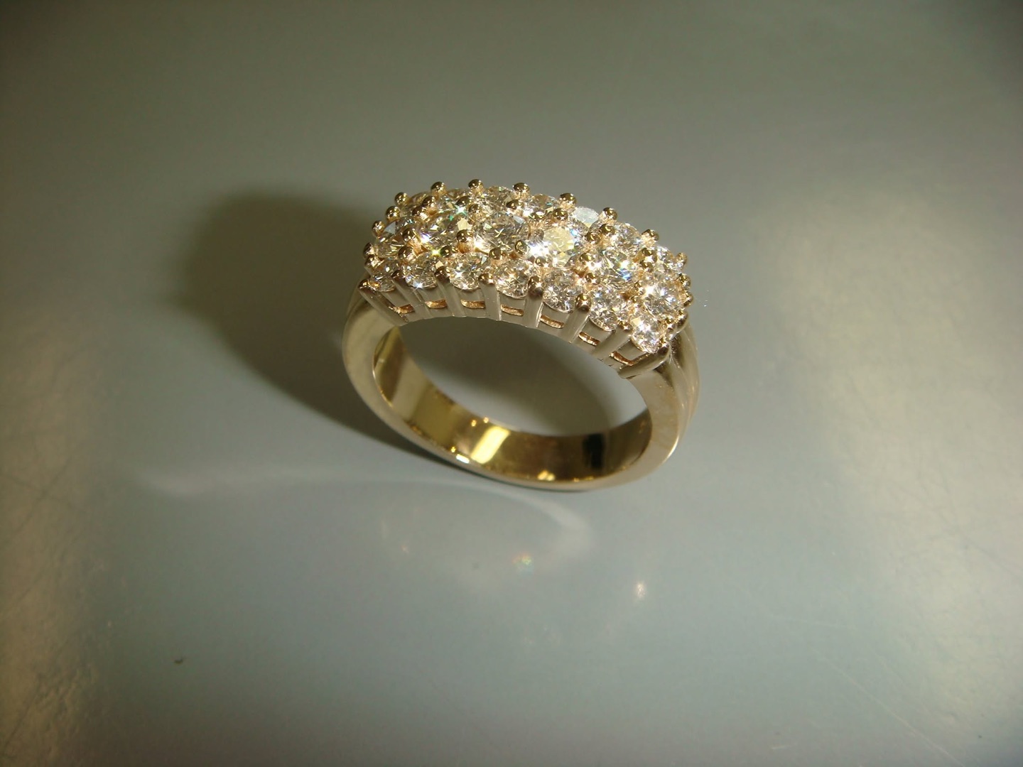 Wide yellow gold band with three rows of diamonds