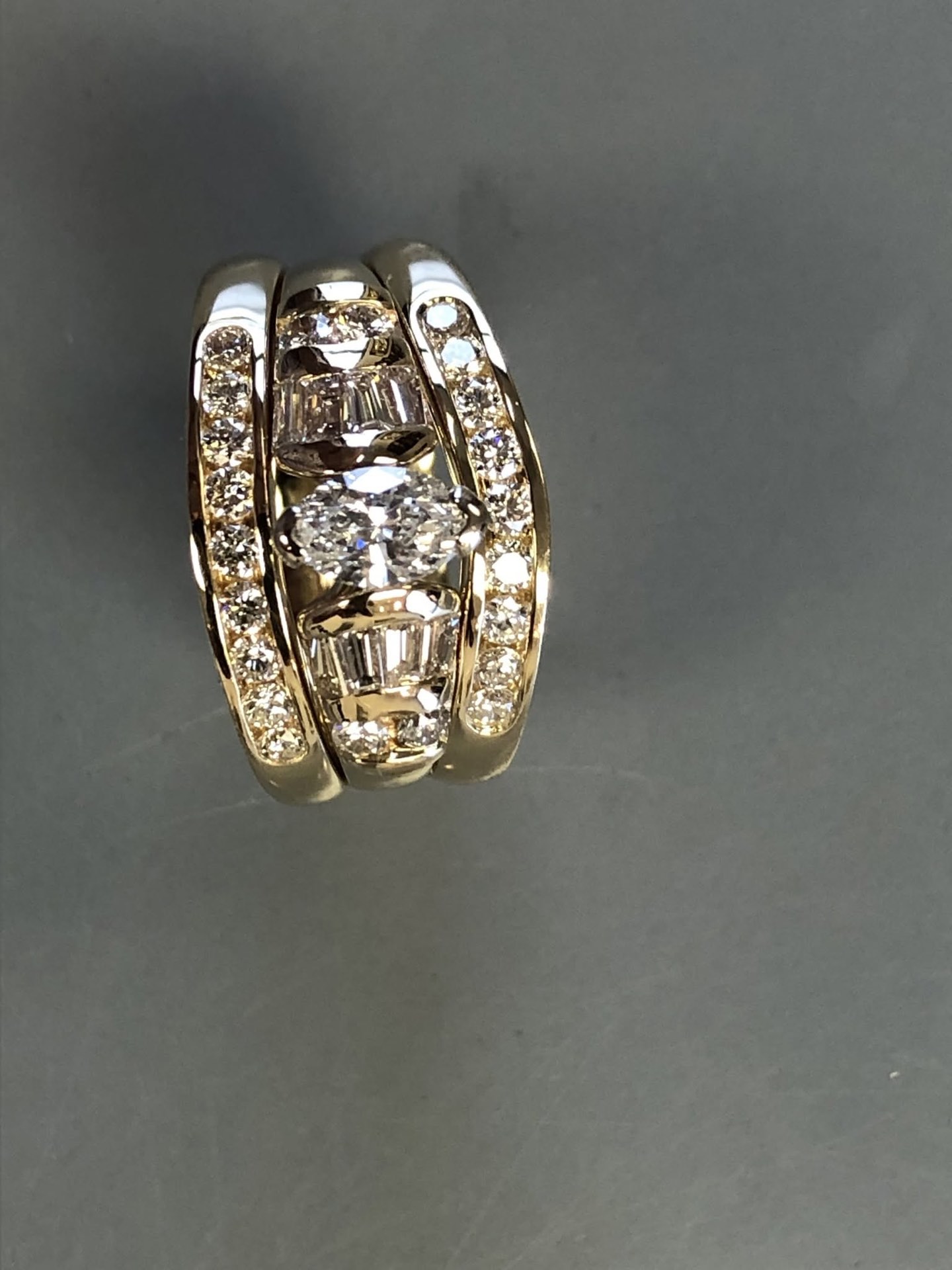Wide gold and white gold band with channel-set diamonds