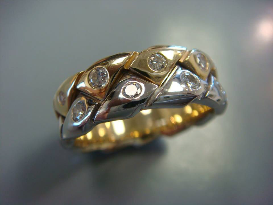 Woven two-tone gold band with bezel-set diamonds