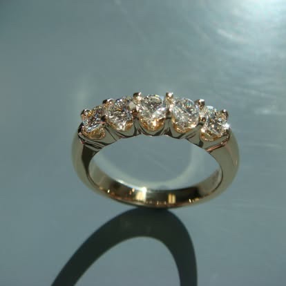 Yellow gold anniversary band with five round diamonds