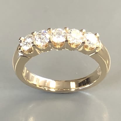 Yellow gold band with five round diamonds